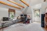 Upstairs bedroom used as an office.  Vaulted ceilings are complemented by exposed beams and the sunlight that pours in from the dormer window.