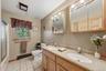 The main bathroom on the first floor is quite spacious and enjoys double sinks, double cabinets, an in-room linen closet and tile floors.