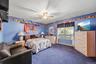 First floor bedroom features a double window, center ceiling fan and generous closet space.