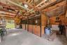 The barn includes 3 stalls, a tack/feed area, electric and a passage door.