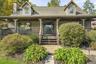 Mature gardens and a generous front porch welcome you home.