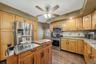 Plenty of quality cabinets, a recessed fridge, enough counter space to prepare a feast, and a side door to the back deck make the kitchen an easy plac