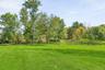 The view from the front yard towards the barn.  How special to have your horses out your front door, and be able to ride right to the Trail.