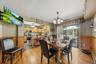 Wainscoting, hardwood floors, and sliders to the deck are a few great features of the dining room.