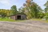 A sweet 3 stall barn with parking for trailers or golf carts!