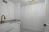 Laundry room with farm sink, cabinets and hook up for washer and dryer