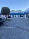 In shopping center/industrial park with Tire Kingdon as Anchor