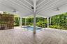 Expansive Tropical Pool Patio Entertainment Area