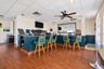 Clubhouse bar, virtually staged, table cleared and TV darkened