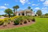 Clubhouse exterior, virtually staged, golf carts removed