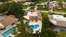From above, the true rarity of this property comes into focus. Perfectly positioned on an oversized cul de sac lot, the home backs directly to a prote