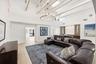 The heart of the home is an extraordinary open concept living space where soaring vaulted ceilings, exposed wood beams, skylights, and walls of hurric