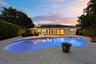 As the sun sets, this remarkable backyard transforms into a private evening retreat where luxury and nature exist in perfect harmony. Backing to a pro