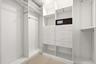 Designed for organization and convenience, this custom walk-in closet offers an impressive amount of storage with built-in shelving, abundant hanging 
