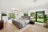Privately tucked behind contemporary frosted glass barn doors, the primary suite is a tranquil retreat designed for comfort and relaxation. Filled wit