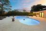 As the sun sets, this remarkable backyard transforms into a private evening retreat where luxury and nature exist in perfect harmony. Backing to a pro
