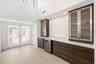 Step inside to a stunning foyer where soaring ceilings, abundant natural light, and wide plank white oak porcelain tile flooring create an unforgettab