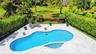 Step outside into your own private resort-style retreat. Designed for both relaxation and entertaining, the expansive marble-look pool deck surrounds 