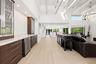 The heart of the home is an extraordinary open concept living space where soaring vaulted ceilings, exposed wood beams, skylights, and walls of hurric