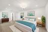 Privately tucked behind contemporary frosted glass barn doors, the primary suite is a tranquil retreat designed for comfort and relaxation. Filled wit