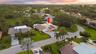 From above, the true rarity of this property comes into focus. Perfectly positioned on an oversized cul de sac lot, the home backs directly to a prote