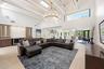 The heart of the home is an extraordinary open concept living space where soaring vaulted ceilings, exposed wood beams, skylights, and walls of hurric