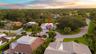 From above, the true rarity of this property comes into focus. Perfectly positioned on an oversized cul de sac lot, the home backs directly to a prote