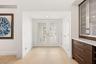 Step inside to a stunning foyer where soaring ceilings, abundant natural light, and wide plank white oak porcelain tile flooring create an unforgettab