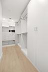 Designed for organization and convenience, this custom walk-in closet offers an impressive amount of storage with built-in shelving, abundant hanging 