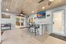 Live the epitome of the South Florida lifestyle with this 1,360 sq. ft. patio. It offers a built-in bar with quartz countertops, a grill area with hoo