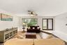 The formal living room provides abundant natural light through the hurricane impact windows and front door.