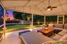 Live the epitome of the South Florida lifestyle with this 1,360 sq. ft. patio. It offers a built-in bar with quartz countertops, a grill area with hoo
