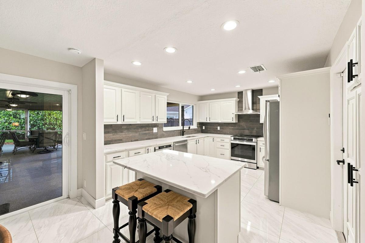 The dining space and eat-in kitchen are highlighted by new floors and a beautifully updated kitchen with quartz countertops and stainless steel applia