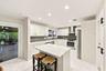 The dining space and eat-in kitchen are highlighted by new floors and a beautifully updated kitchen with quartz countertops and stainless steel applia