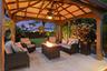A built-in gazebo with electric offers a private, cozy space to relax and unwind. Beyond the pool is a space big enough to fit an RV, boat, golf simul