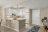 The kitchen also features a breakfast bar, 42" cabinets, recessed lighting, and an elegant flow into the roomy foyer.