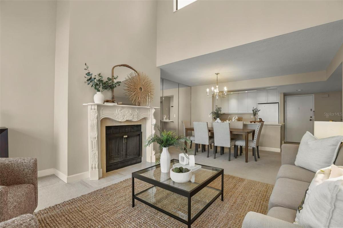 The living room is anchored by a gorgeously framed fireplace, a hard-to-find amenity in a condo home!