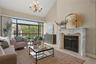Vaulted ceilings, a wood-burning fireplace, and expansive windows give a hint of how remarkable this condo is.