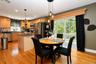 Kitchen featuring  stainless steel appliances, a center island with countertop, wood-finish flooring and sliders to the rear pool area