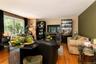 Wood-finish flooring throughout, featuring , a window with dark drapery, part of the great room