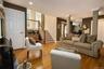 Hardwood flooring, painted interior doors, recessed lighting, white trim, decorative columns, and a wooden staircase with balusters