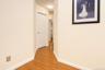 Wood-finish flooring with light-toned walls and white trim