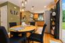 Hardwood flooring, recessed lighting, pendant light fixtures and sliding glass door to rear 2 tiered paver patio