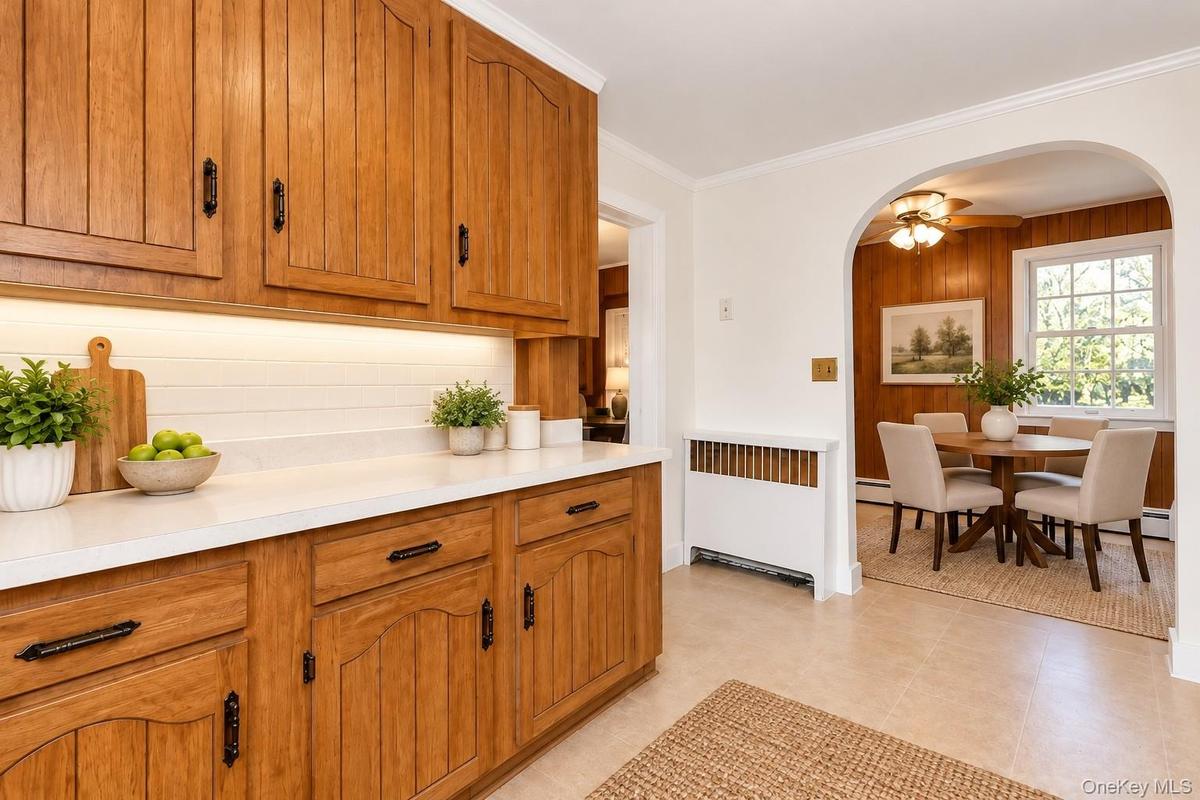 Virtually Staged Eat-In Kitchen and Dining AreaThis charming eat-in kitchen has been thoughtfully virtually staged to highlight its warmth, functional