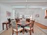 Vaulted ceilings with exposed beams, recessed lighting, and a ceiling fan