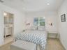 Spacious Bedroom with recessed lighting.