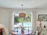 Casual Breakfast area/office space overlooks pool and mature landscaping.