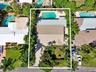 Private swimming pool, expansive backyard, mature landscaping, paved driveway, metal roof