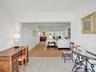 Light tile flooring extending into an open-concept living area.