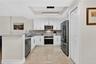 Updated kitchen with quartz counters, new appliances, designer lighting